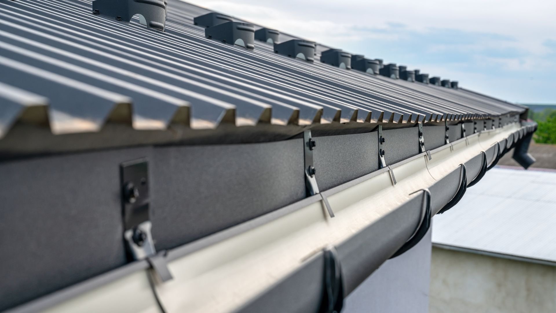 Close-up of metal roof with gutters and modern architectural details