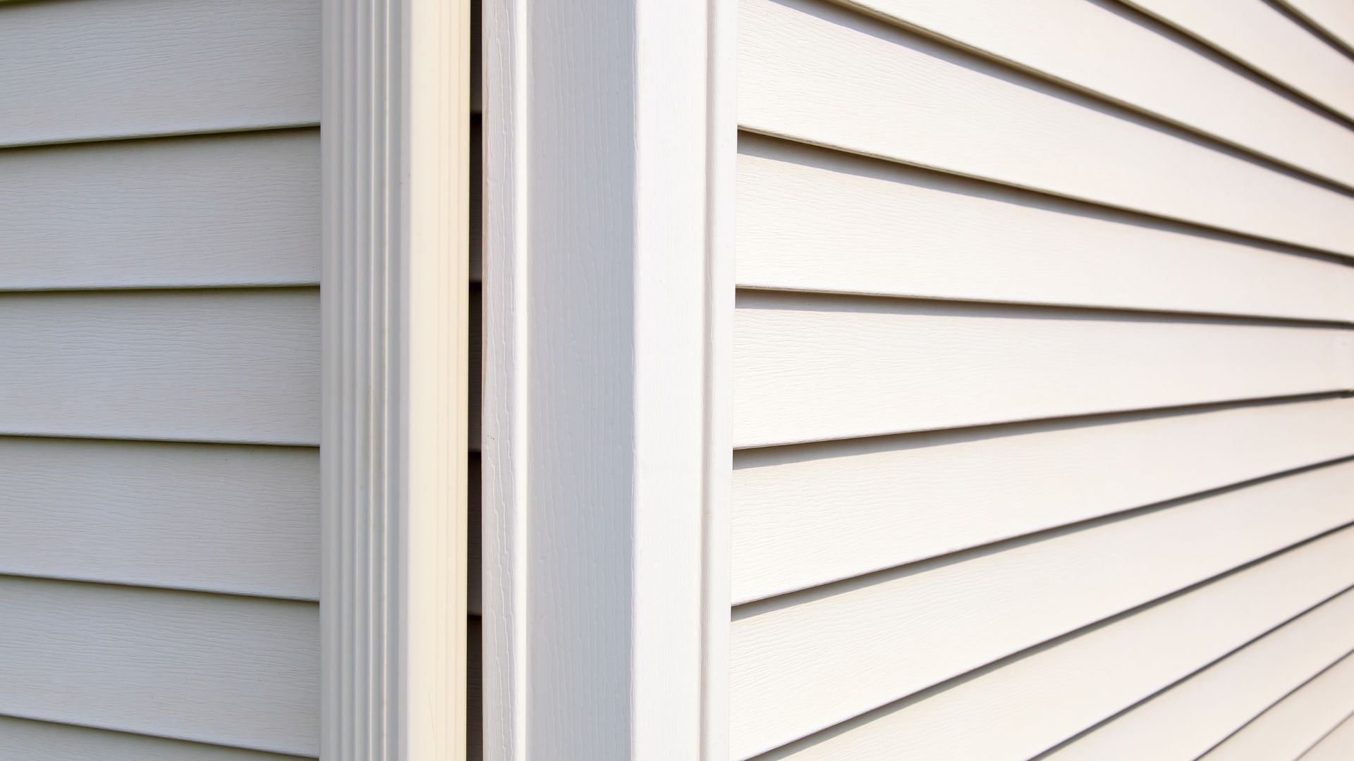 White vinyl siding with horizontal lines and corner trim